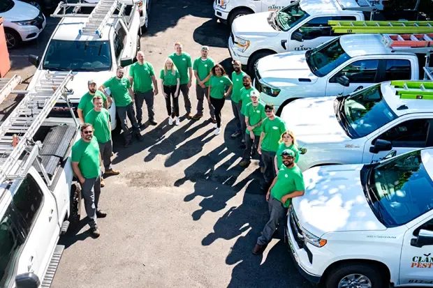 Clancy Bros Pest Control Team standing next to fleet of trucks, Boston.