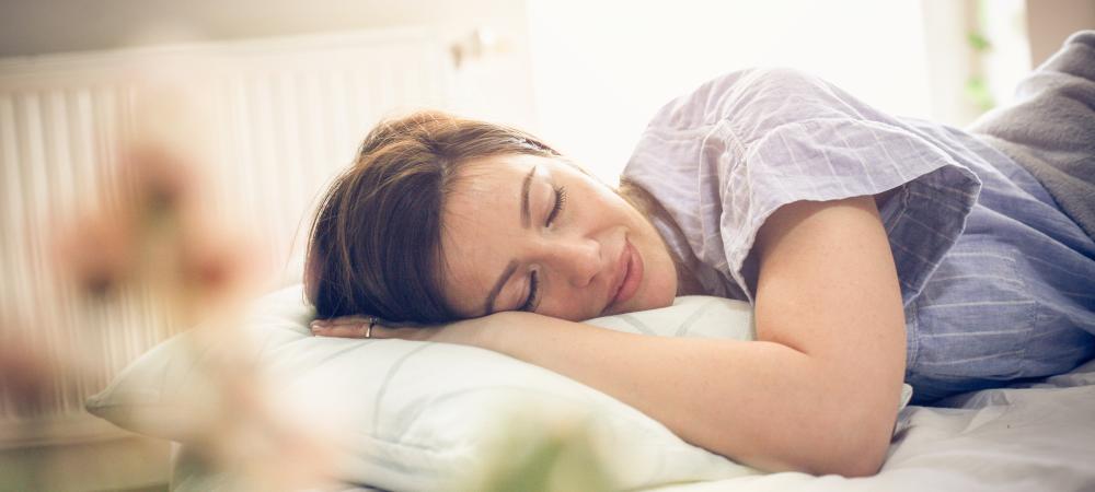 Woman sleeping alone in her bed bug free bed.